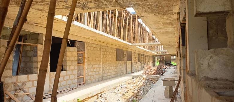 A building under construction with a concrete walkway
Description automatically generated with medium confidence